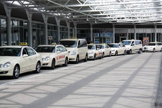 smiling passenger near taxi stand airport transfer